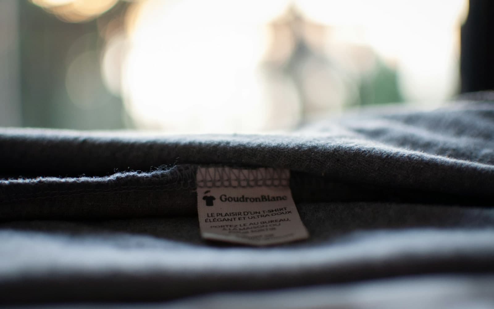 Close-up of a fabric label sewn into the collar of a shirt