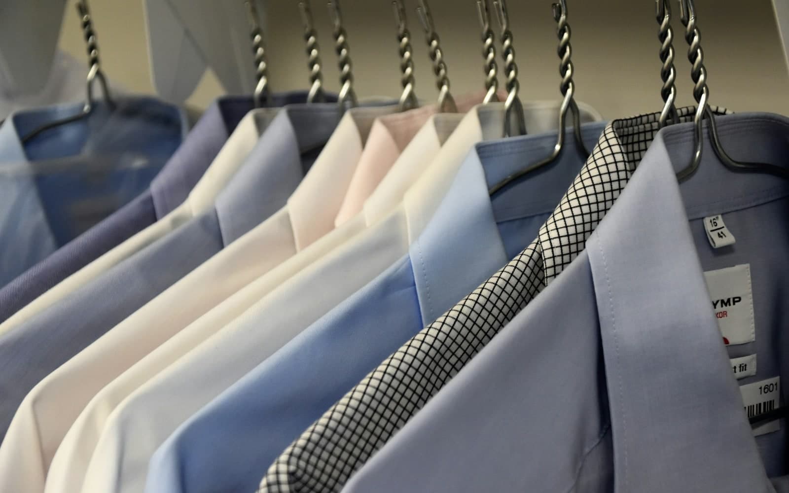 Formal suit jackets in assorted colours hanging on a rail