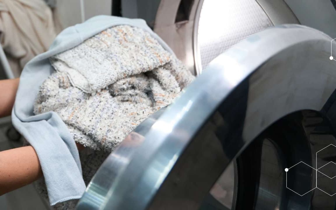 Textiles being loaded into a washing machine, BÜFA Cleaning textile care