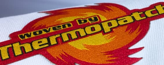 Woven heat transfer emblems and corporate logo patches