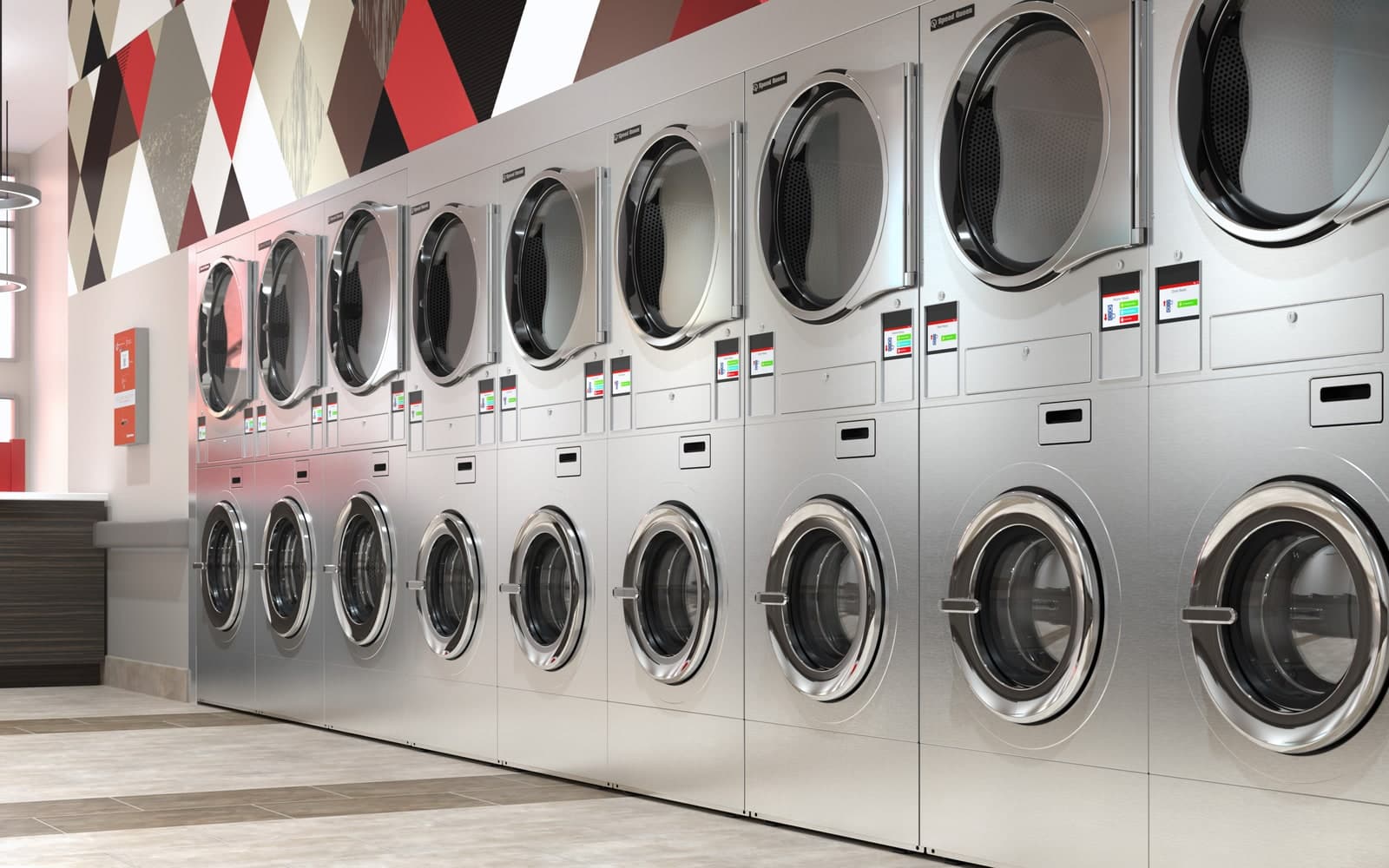 Bank of Speed Queen commercial washer-extractors in a laundry