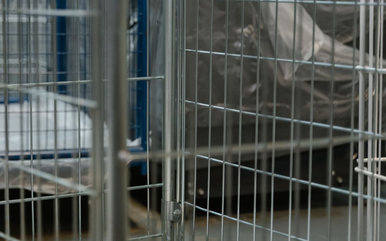 Metal laundry trolley filled with white linen in an industrial laundry