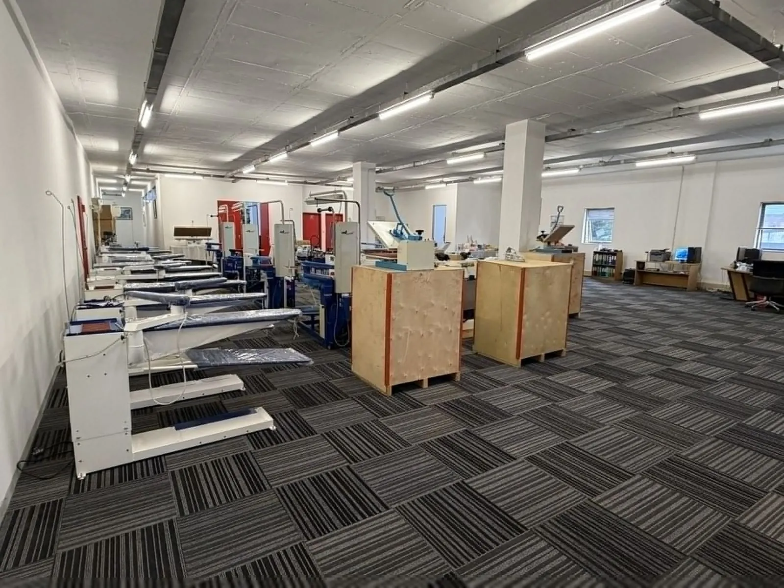 The Universe Corp showroom floor in Wynberg, Sandton, with pressing and finishing machines in rows