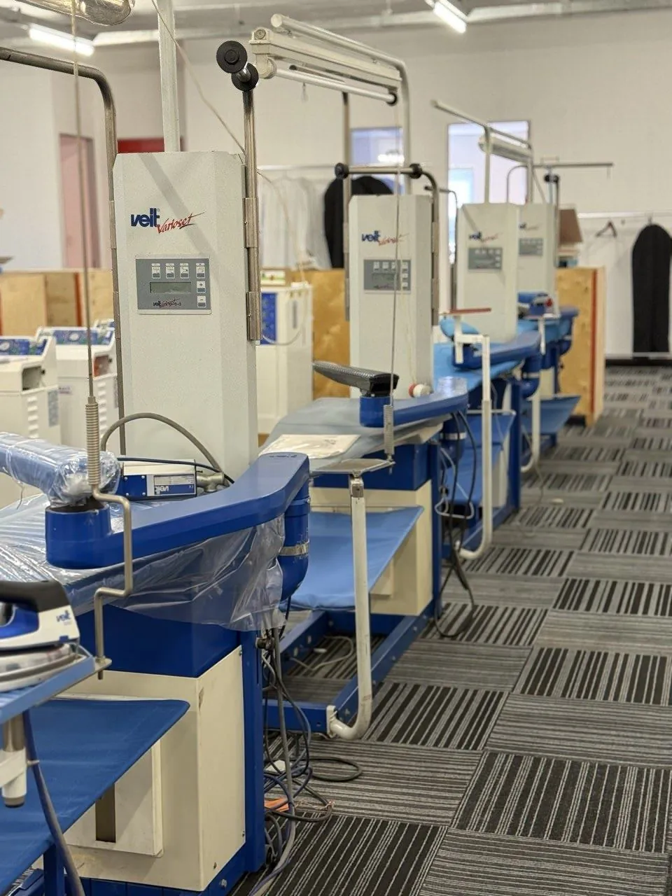 A row of VEIT finishing machines on the showroom floor